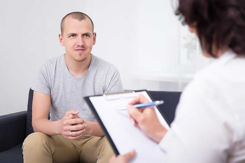 Man undergoing counseling at a heroin addiction treatment center