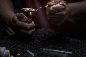 an individual showing classic signs of heroin use
